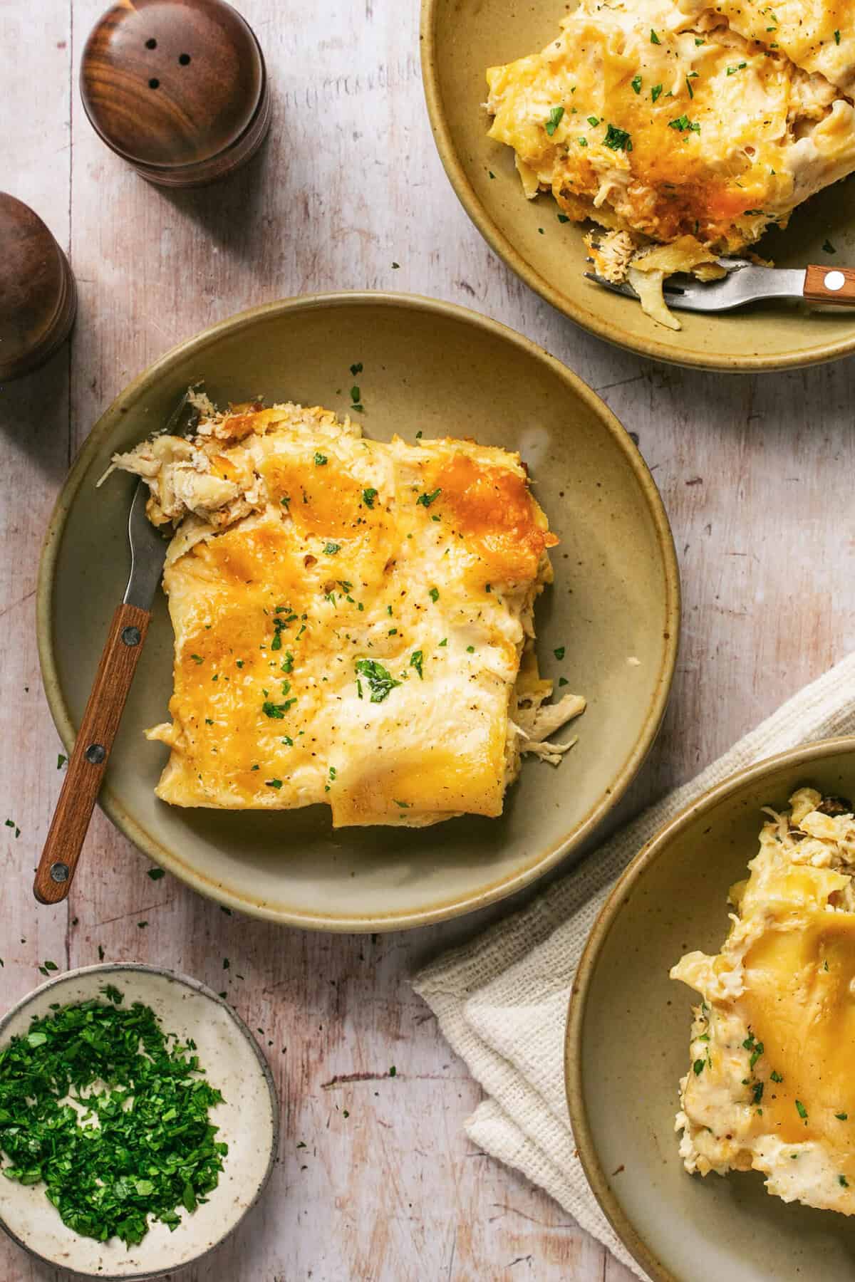 three bowls of lasagna on table.