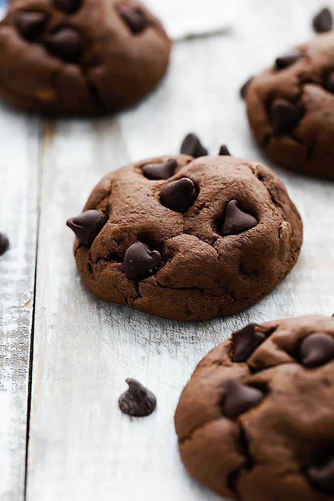 a fudgy double chocolate cookie with more cookies around it.