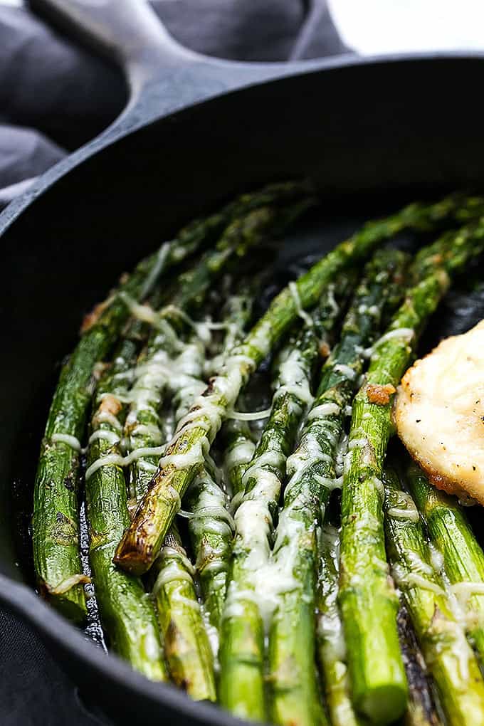 close up of asparagus in a cast iron skillet.