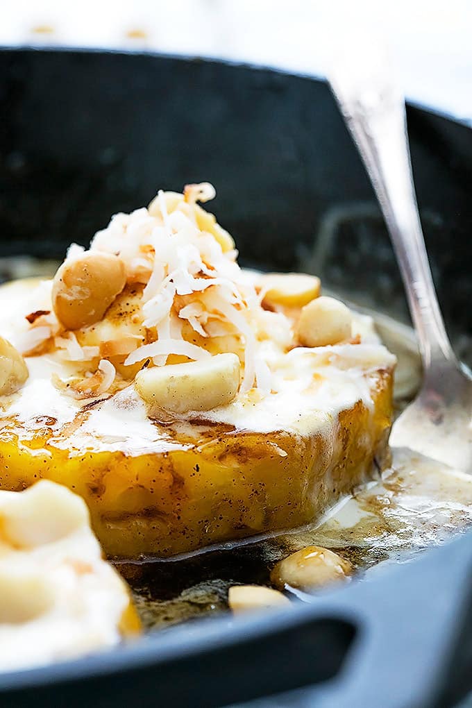close up of a caramelized pineapple sundae with a spoon on the side in a cast iron.