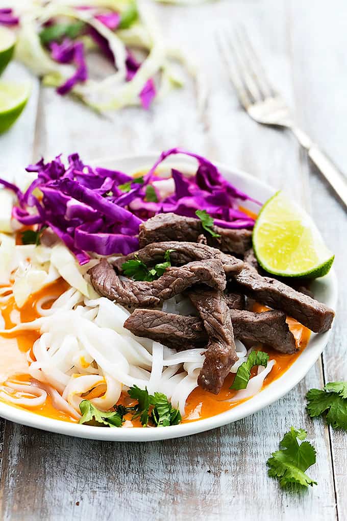 a Thai curry steak noodle bowl with a fork on the side.