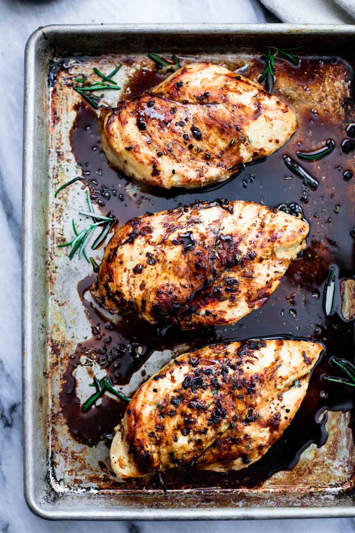top view of baked balsamic chicken on a baking sheet.