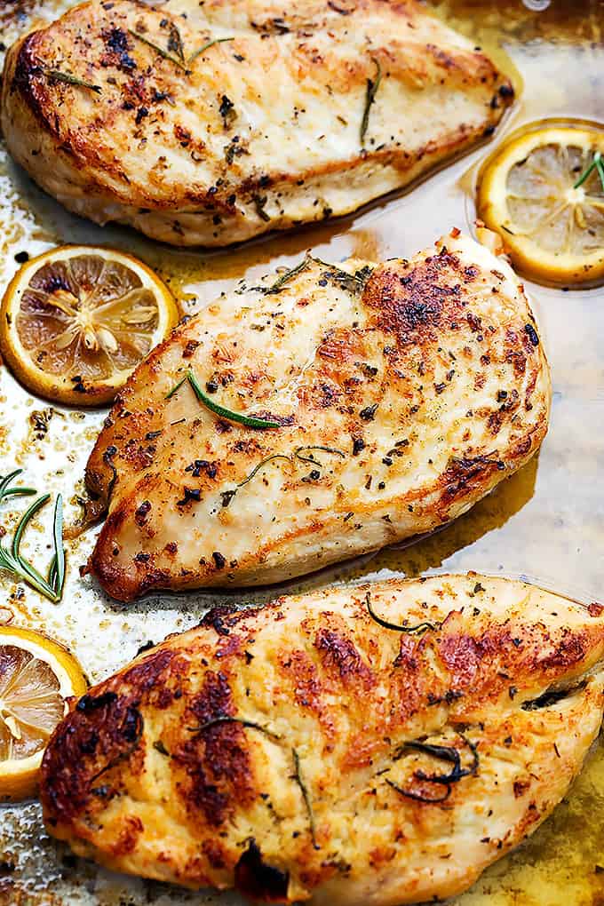 baked lemon chicken with lemon wheels on the side.