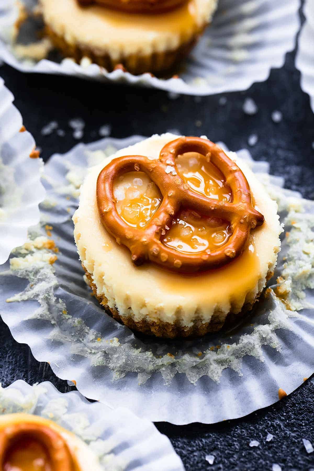 a salted caramel pretzel mini cheesecake with the cupcake liner open.