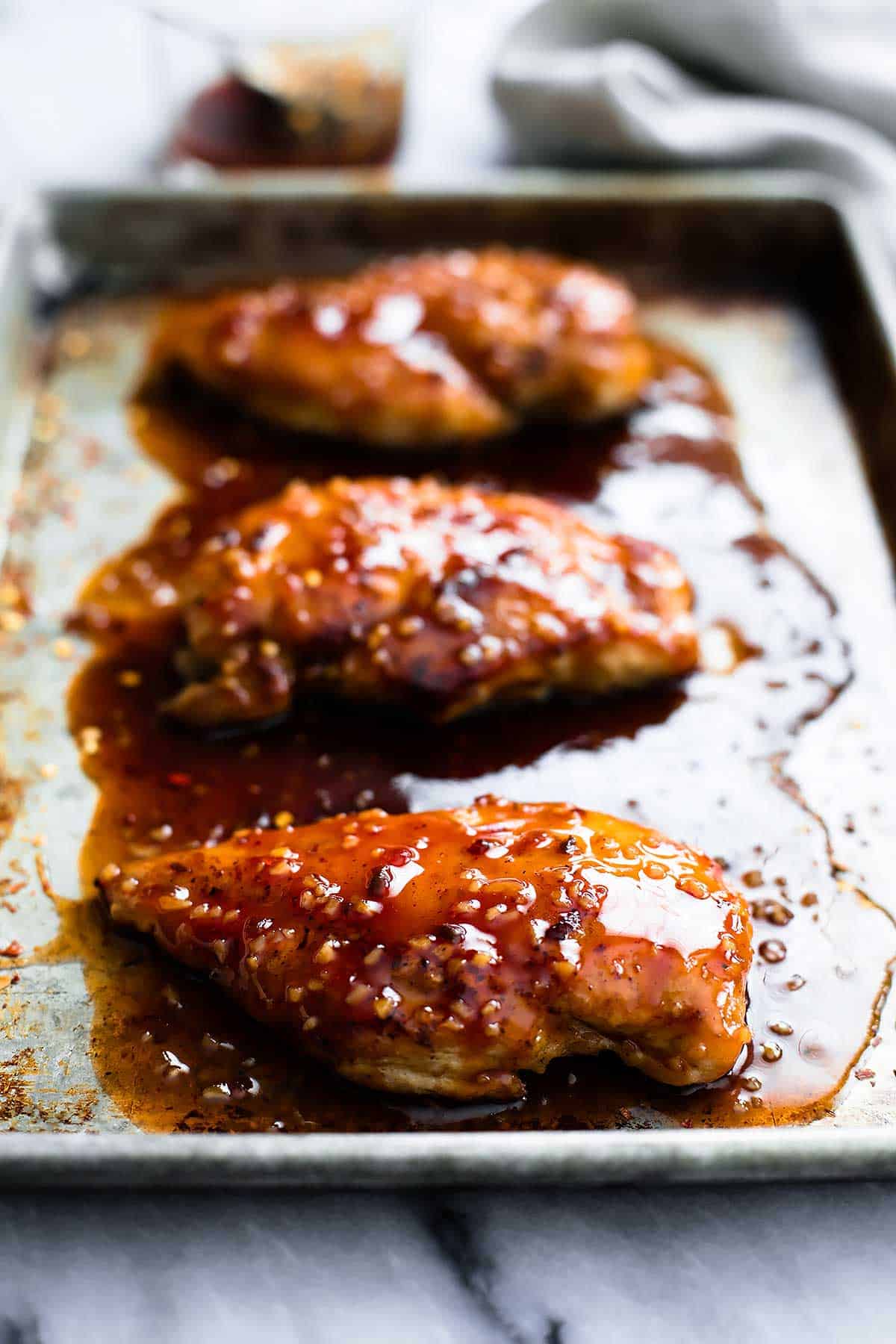 baked sweet & spicy chicken on a baking sheet.