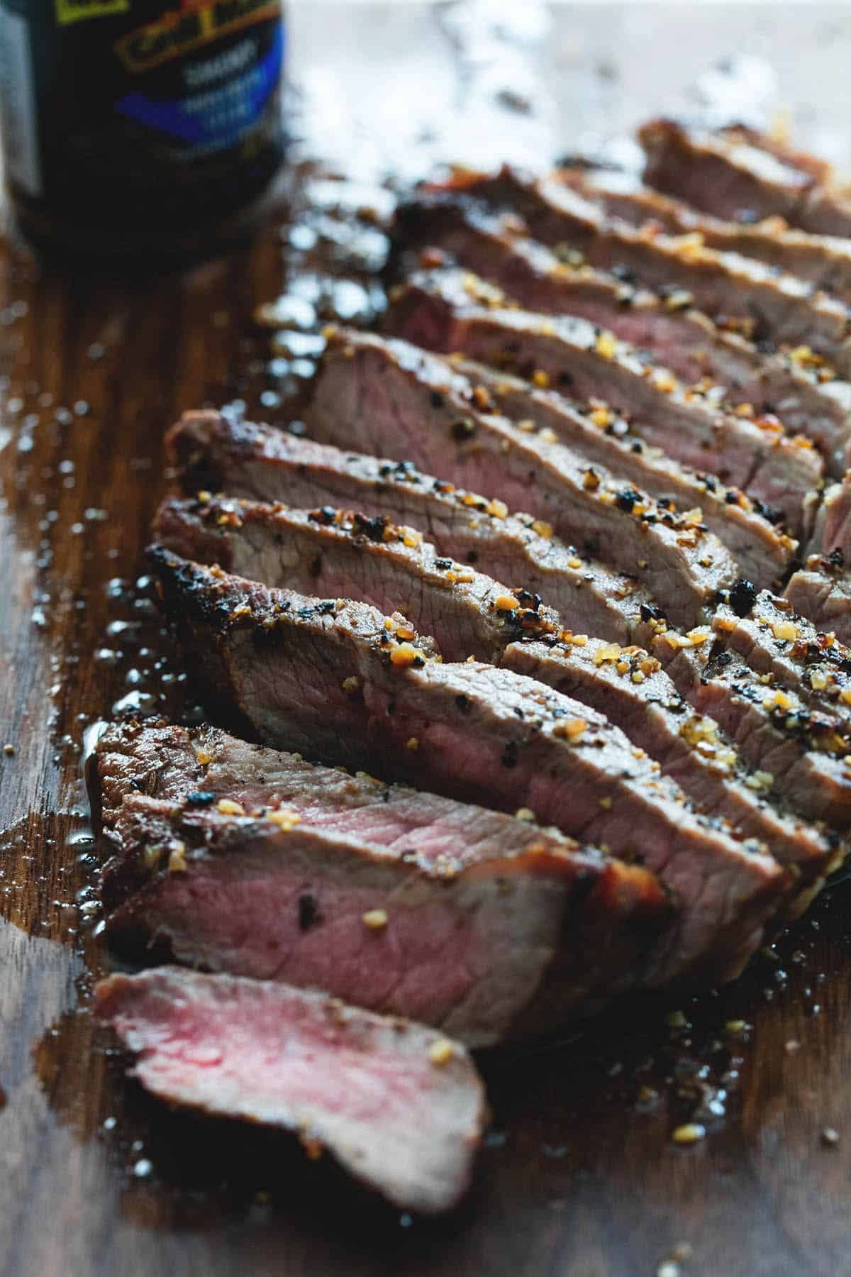 close up of a grilled steak sliced up.