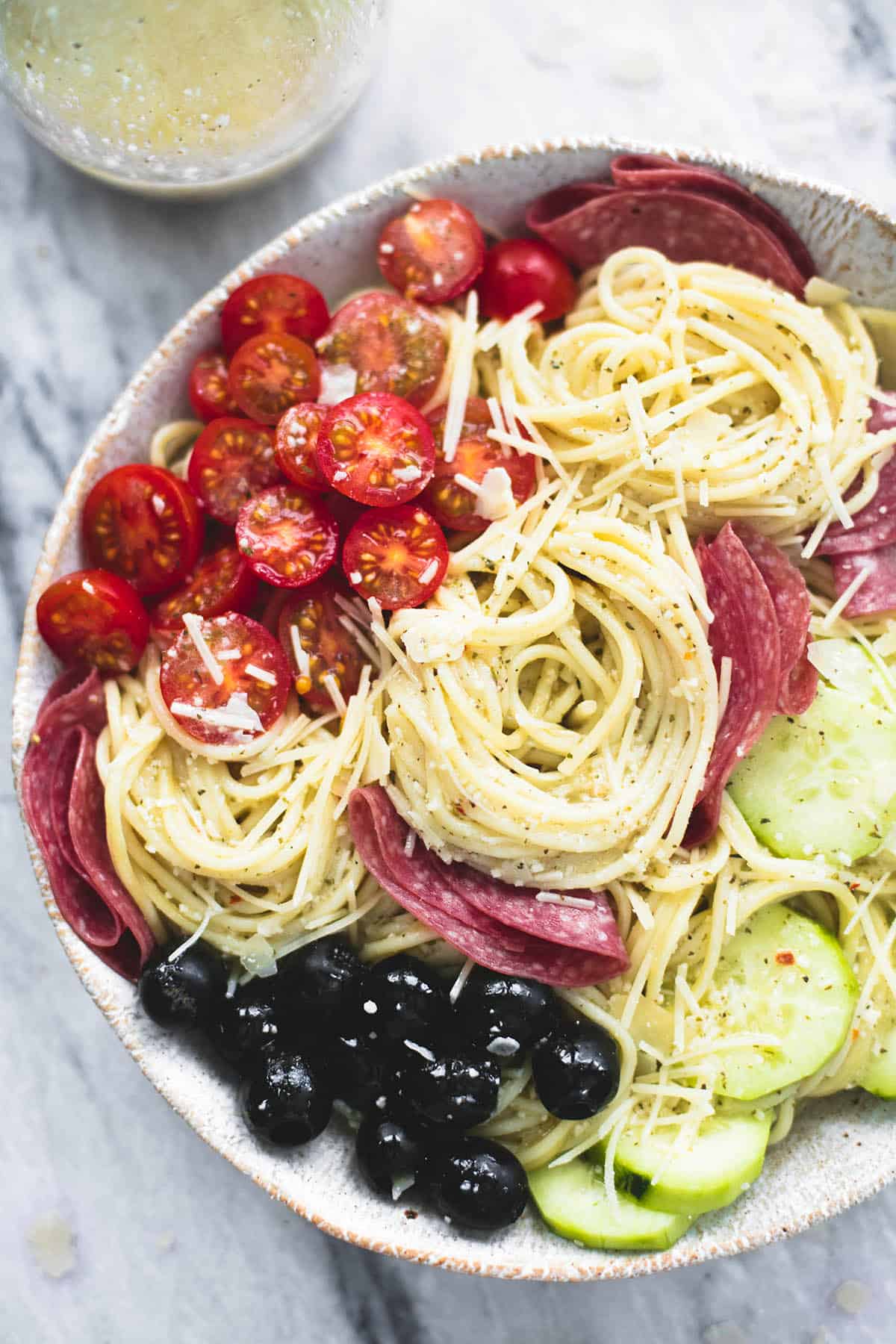 top view of the ingredients of creamy Italian spaghetti pasta salad not yet tossed together.