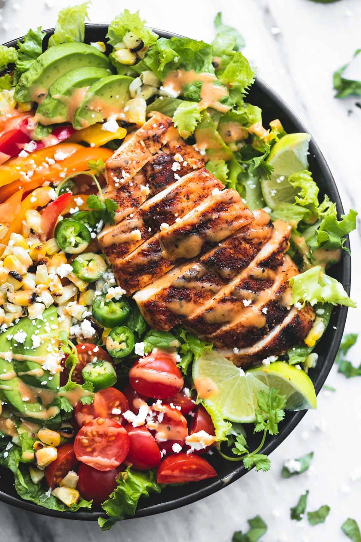 close up top view of fiesta lime chicken salad with chipotle dressing in a bowl.