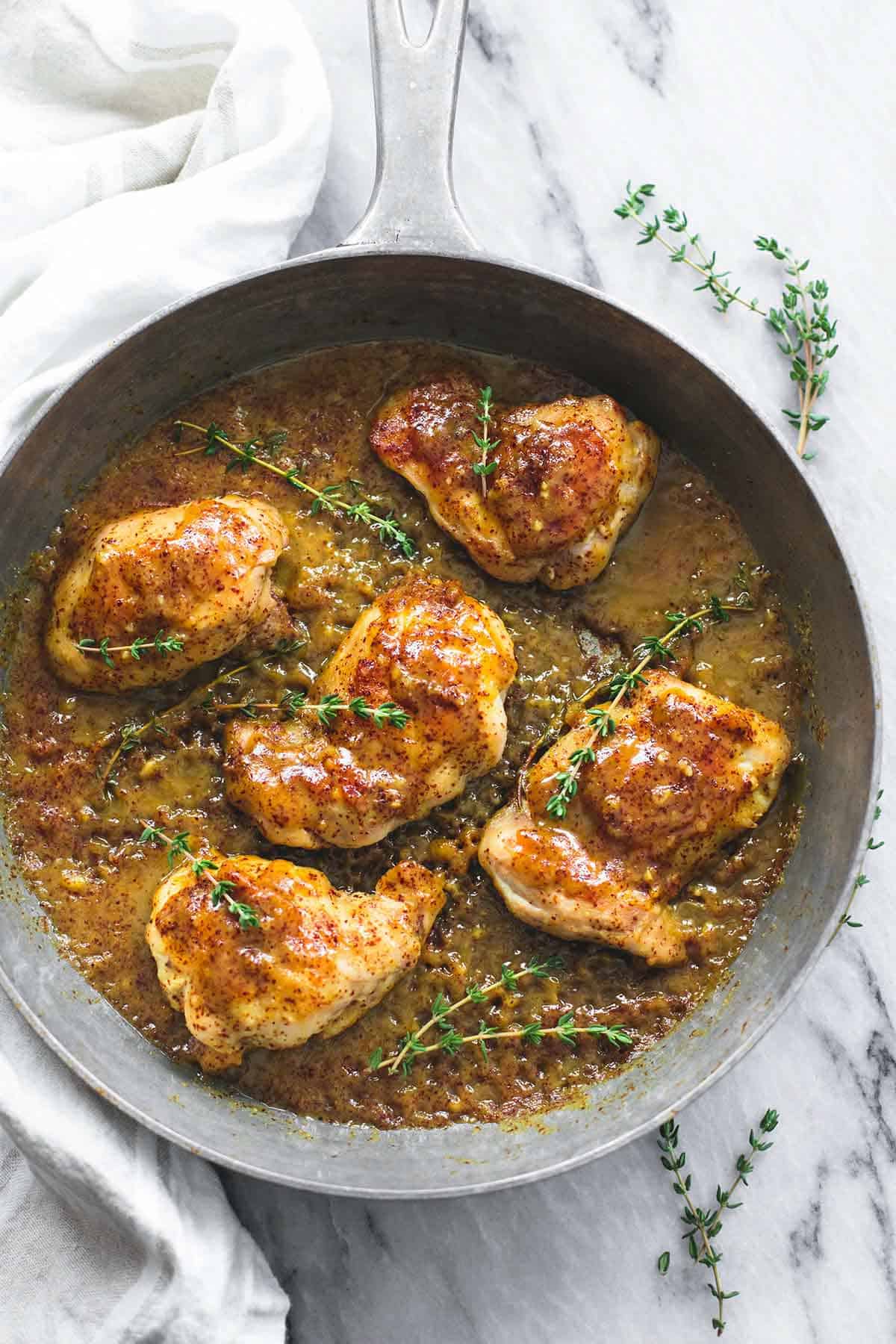 top view of maple mustard glazed chicken in a skillet.