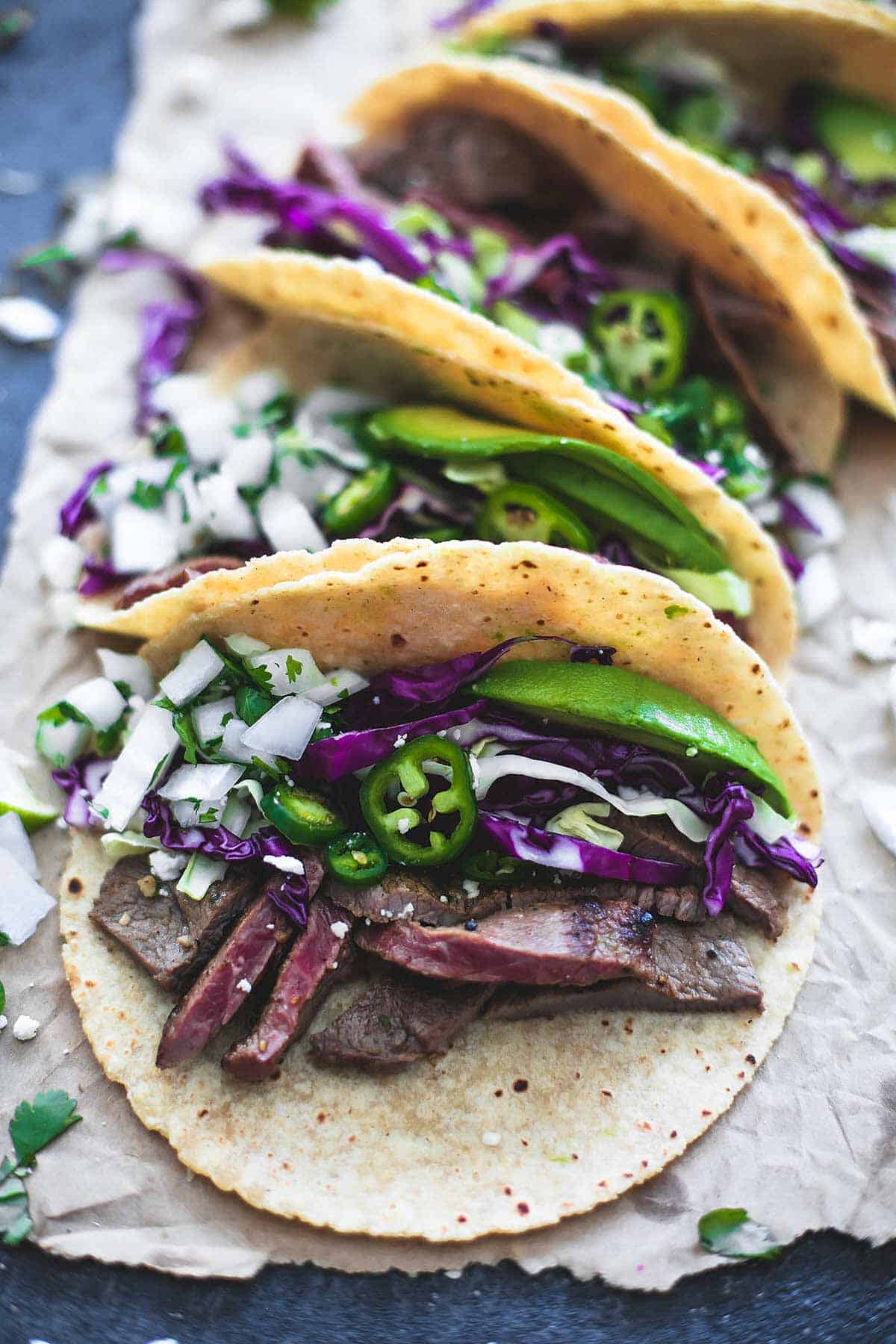 mojo steak tacos lined up one behind the other.