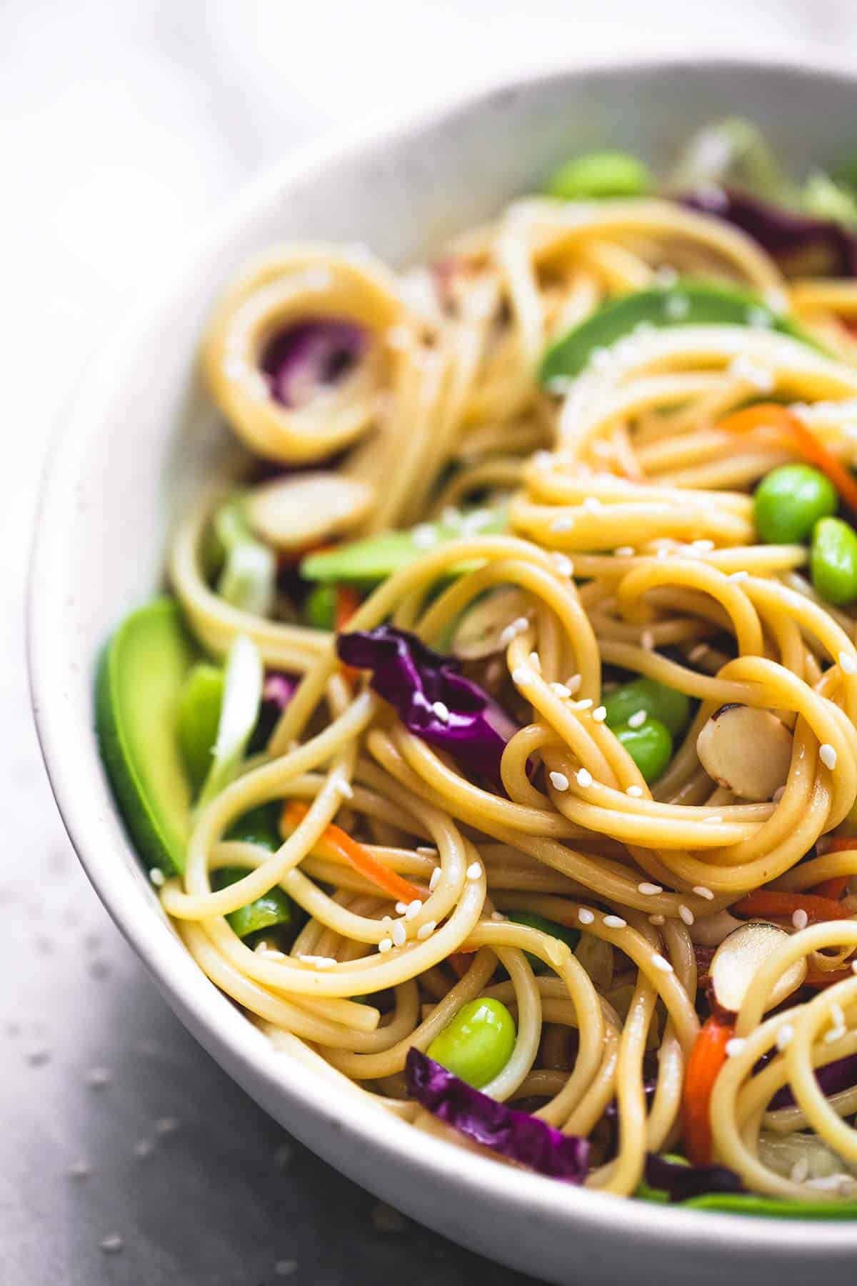 close up of Asian spaghetti salad with sesame ginger dressing in a bowl.