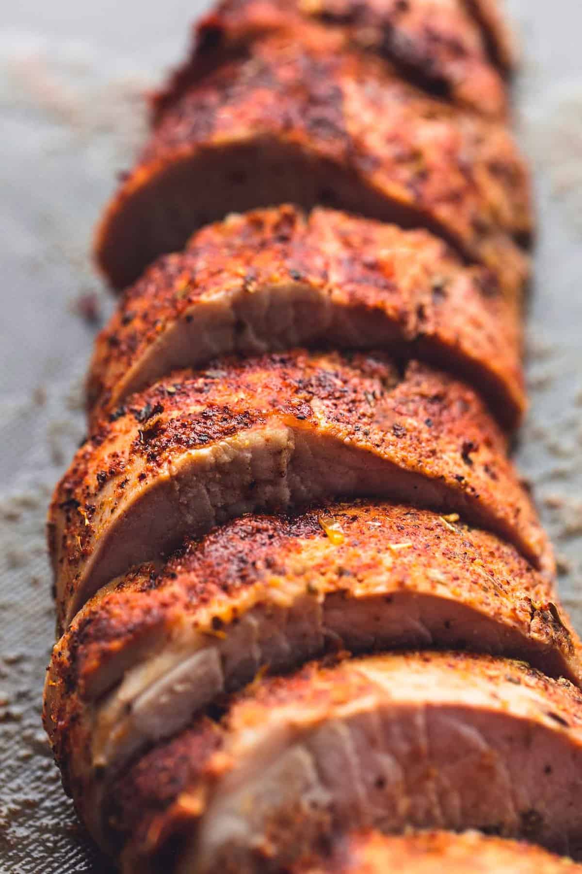 Up close sliced pork tenderloin on a cutting board