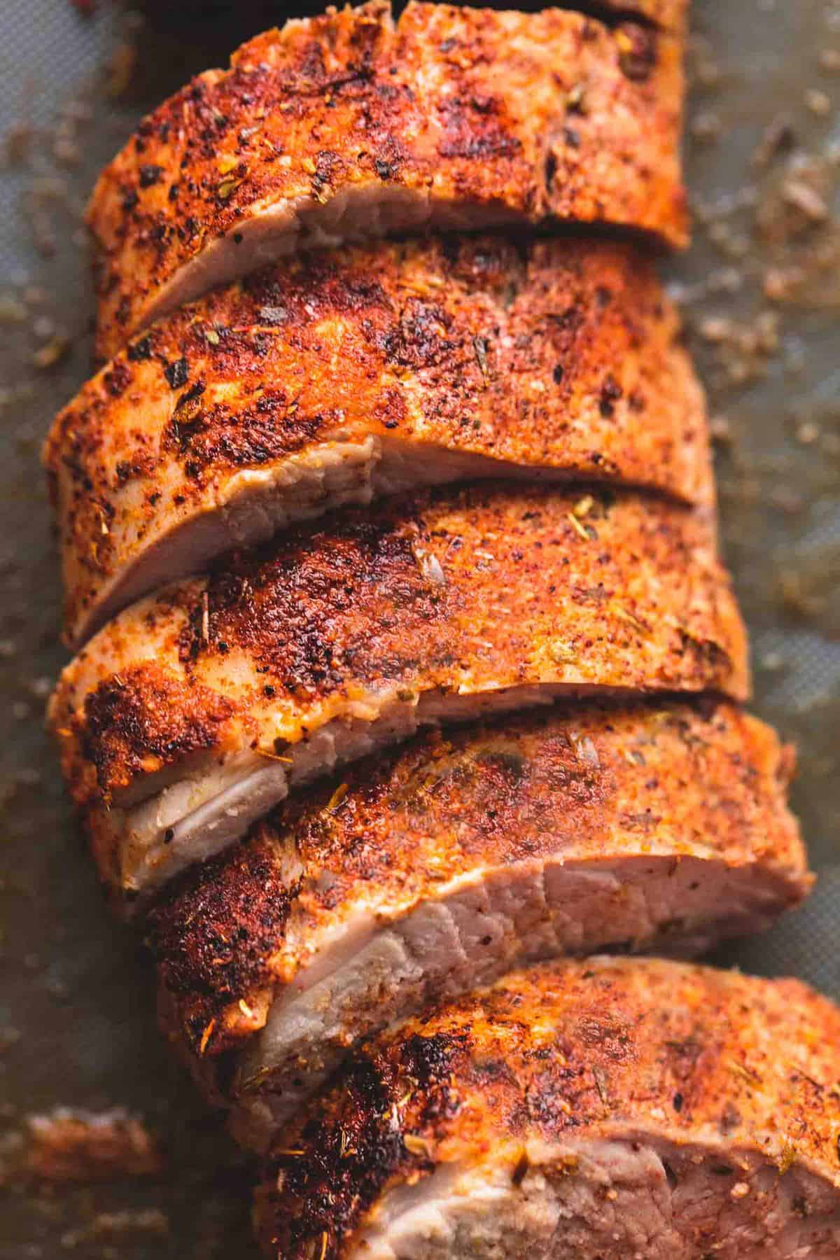 Up close sliced pork tenderloin on a cutting board