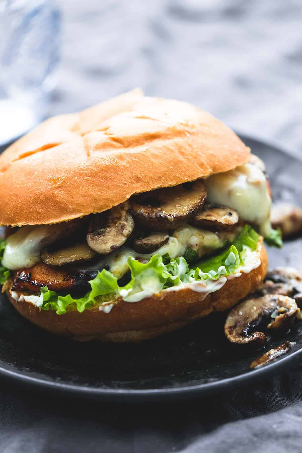 a brown sugar bourbon chicken & mushroom melt on a plate.