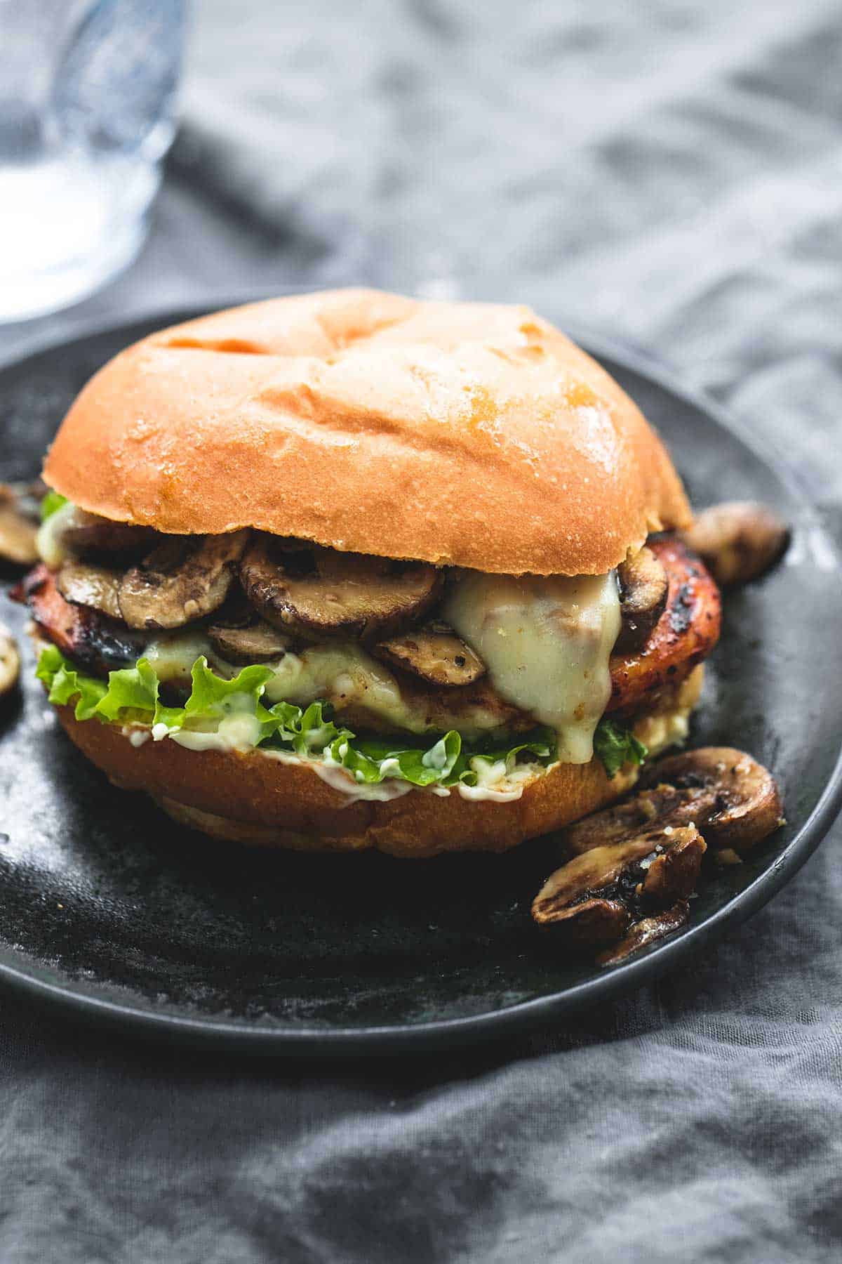 a brown sugar bourbon chicken & mushroom melt on a plate.