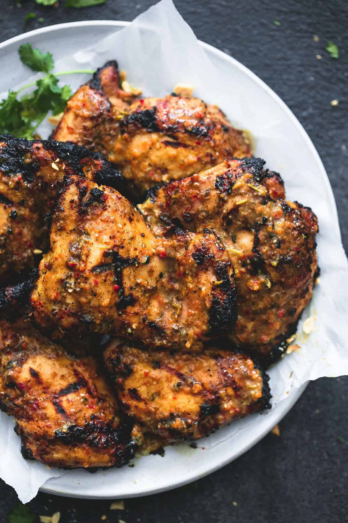 top view of grilled Jamaican jerk chicken on a plate.