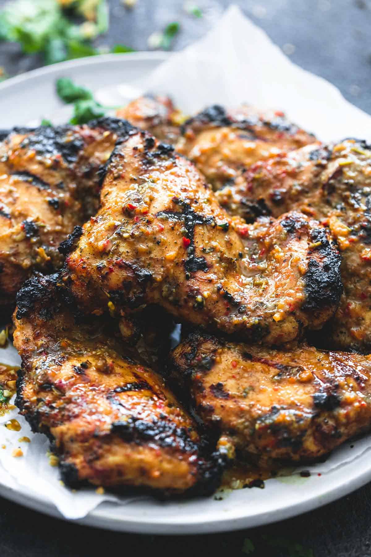 close up of grilled Jamaican jerk chicken on a plate.