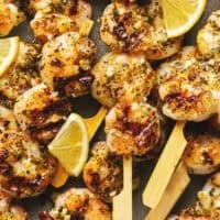 grilled lemon shrimp with garlic sauce on skewers.