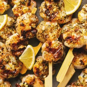 grilled lemon shrimp with garlic sauce on skewers.