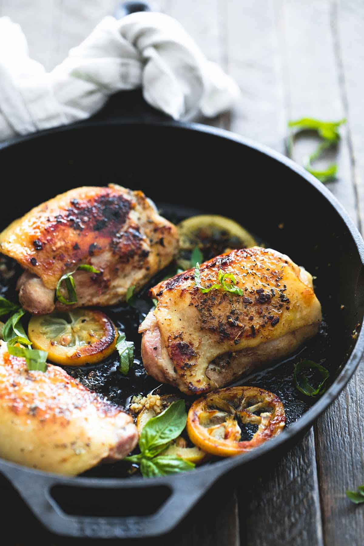 buttery lemon herb chicken thighs in a skillet.