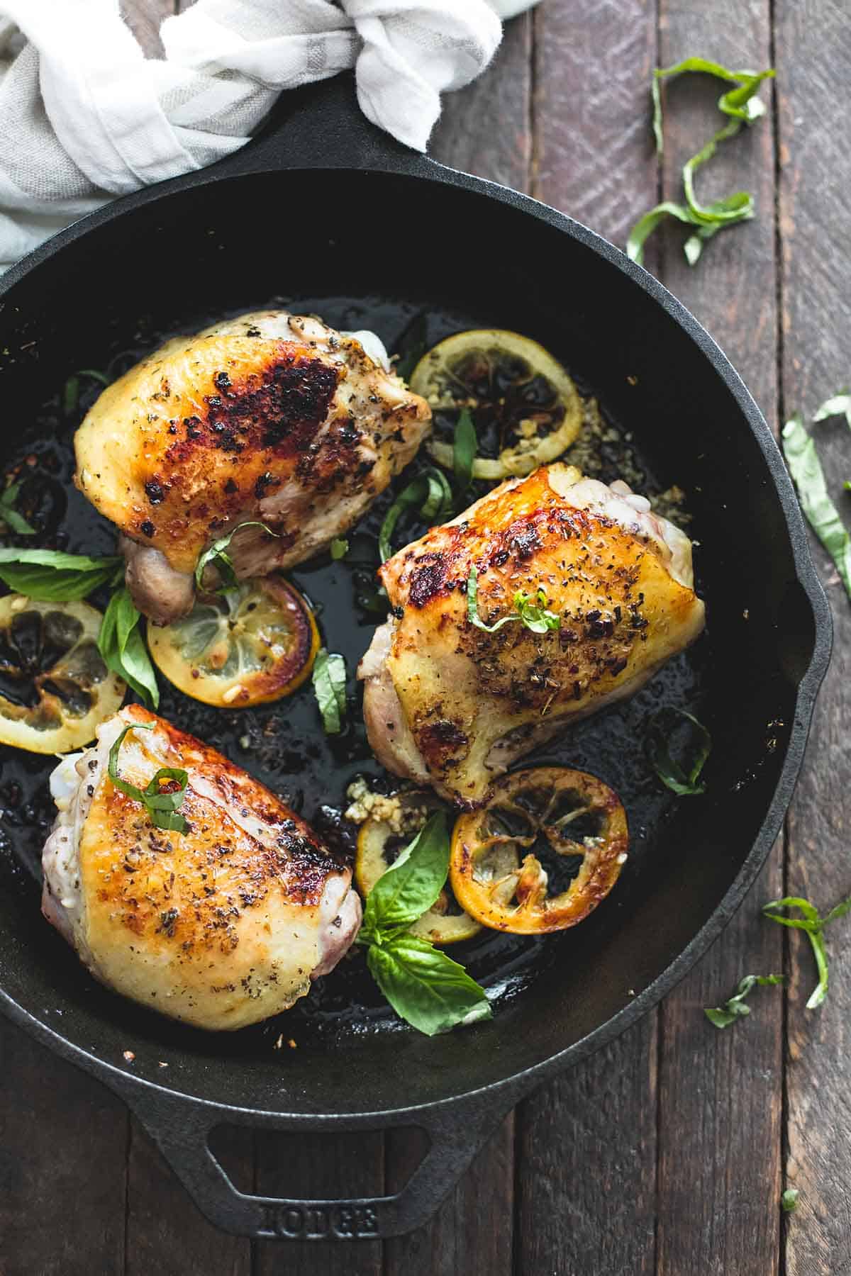 top view of buttery lemon herb chicken thighs in a skillet.
