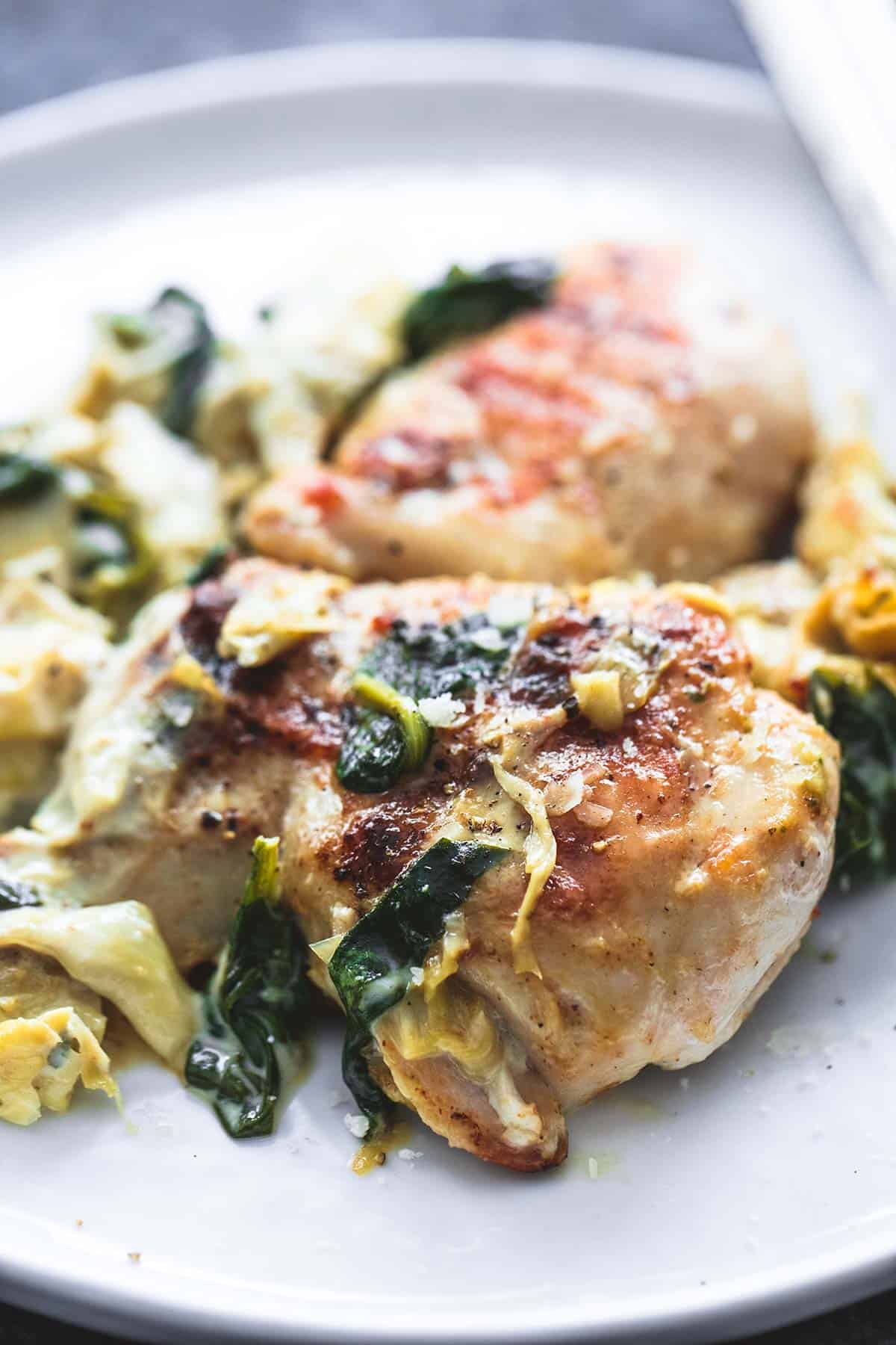 spinach artichoke chicken on a plate.