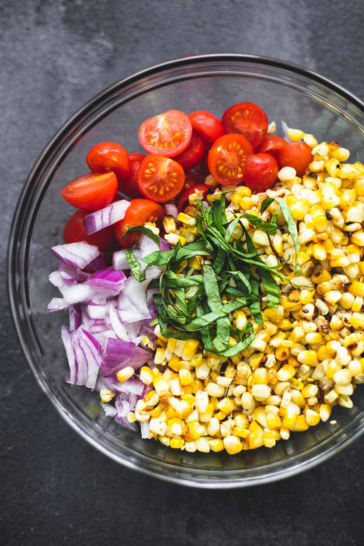 top view of grilled corn salad ingredients not yet tossed in a bowl.