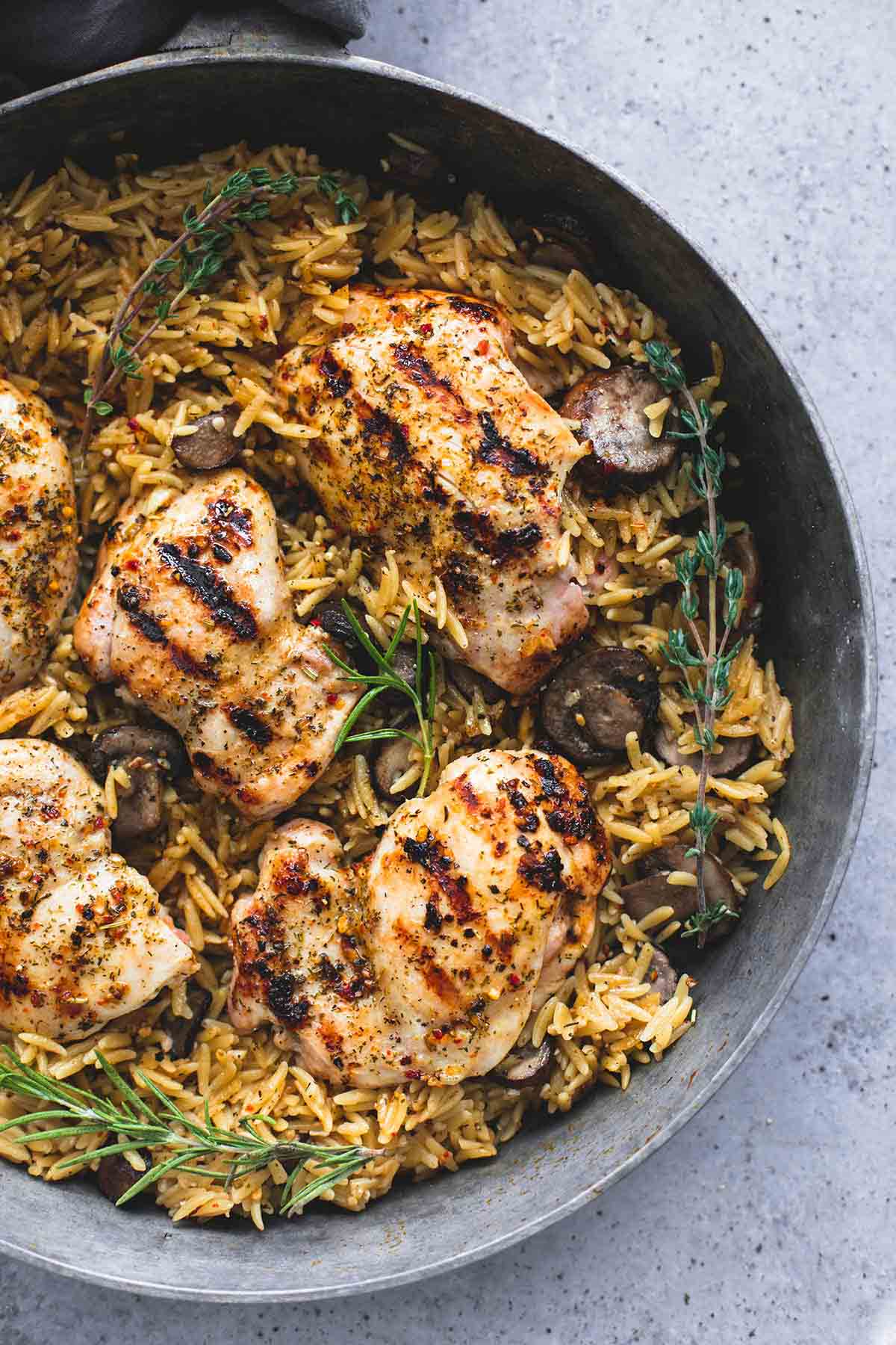 top view of mushroom herb chicken orzo in a pan.
