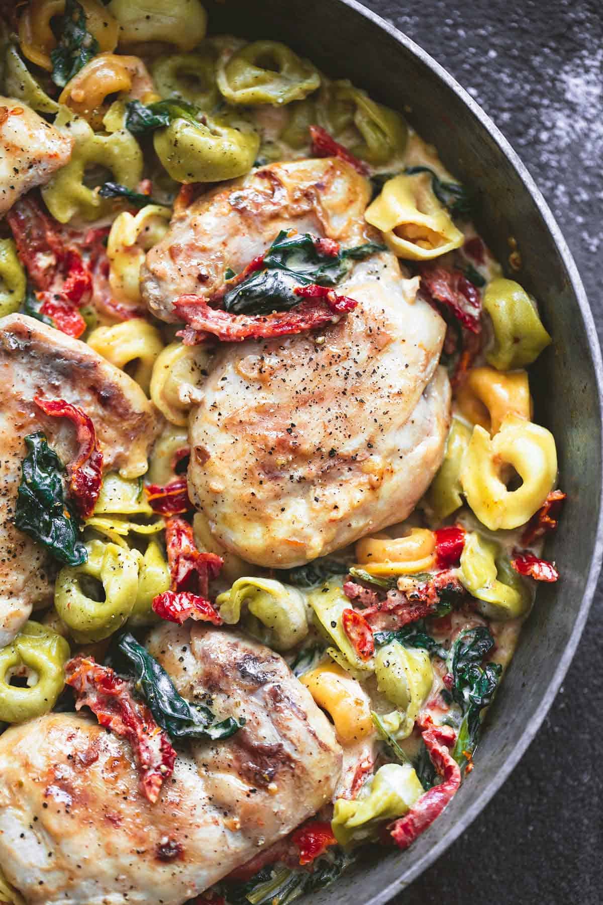 close up top view of Tuscan garlic chicken tortellini in a pan.