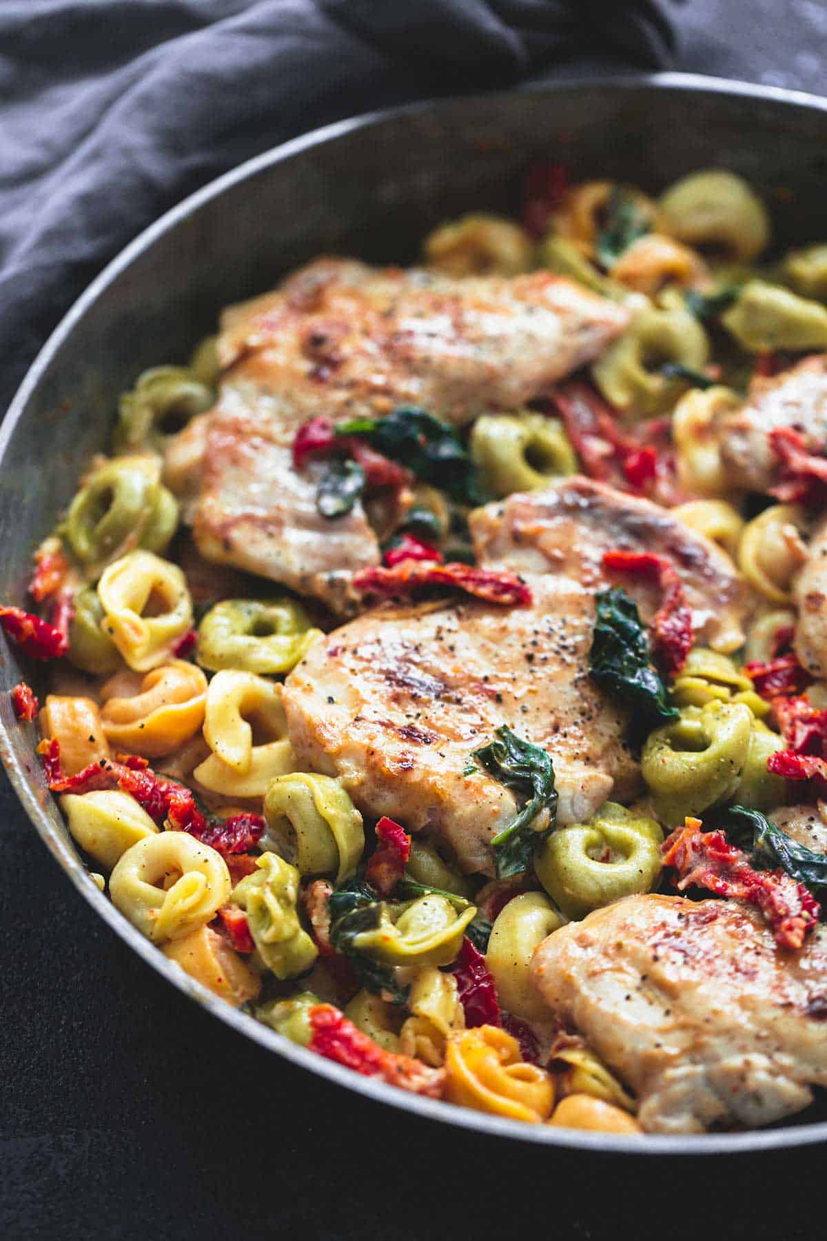 close up of Tuscan garlic chicken tortellini in a pan.