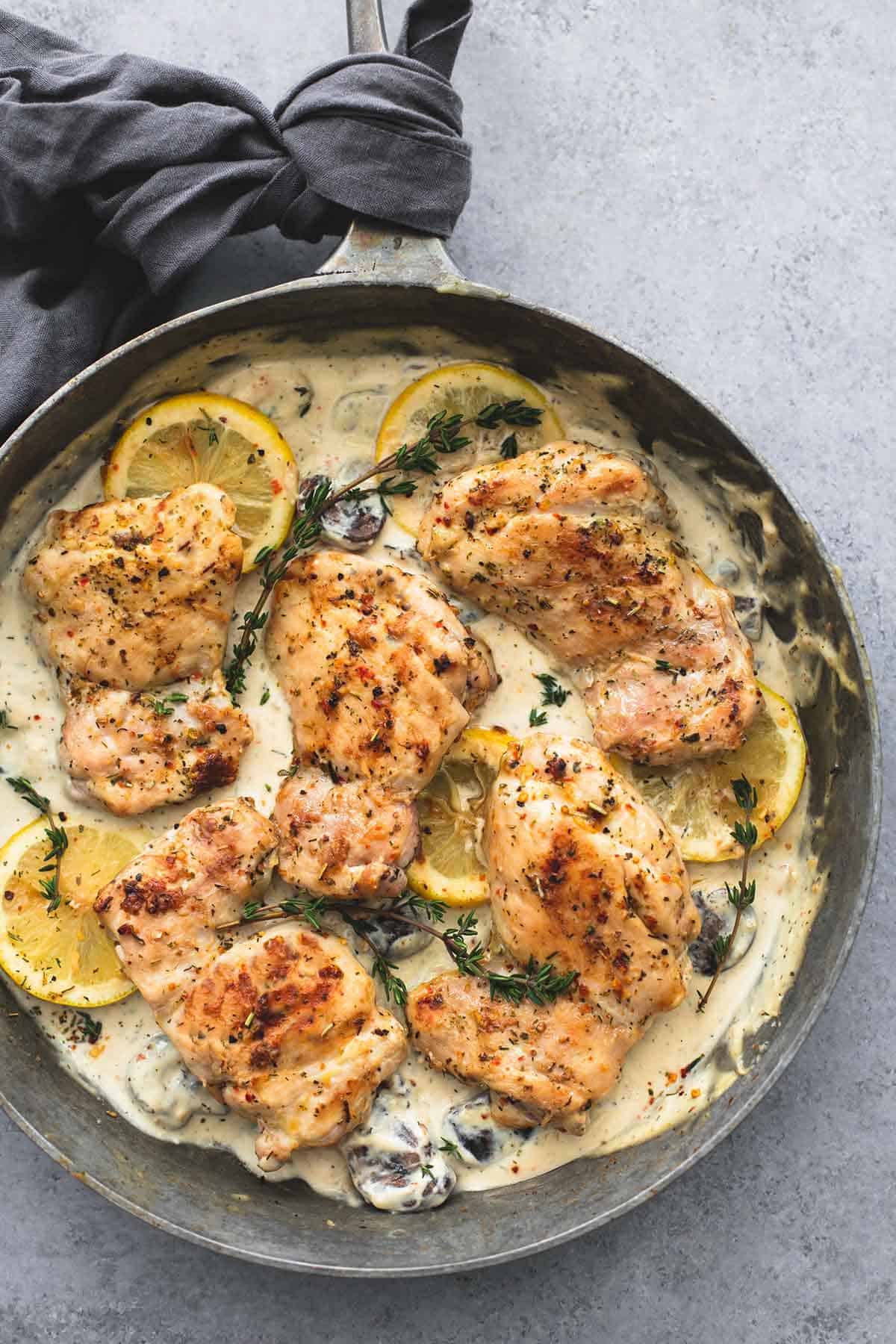 top view of creamy lemon thyme chicken in a pan.