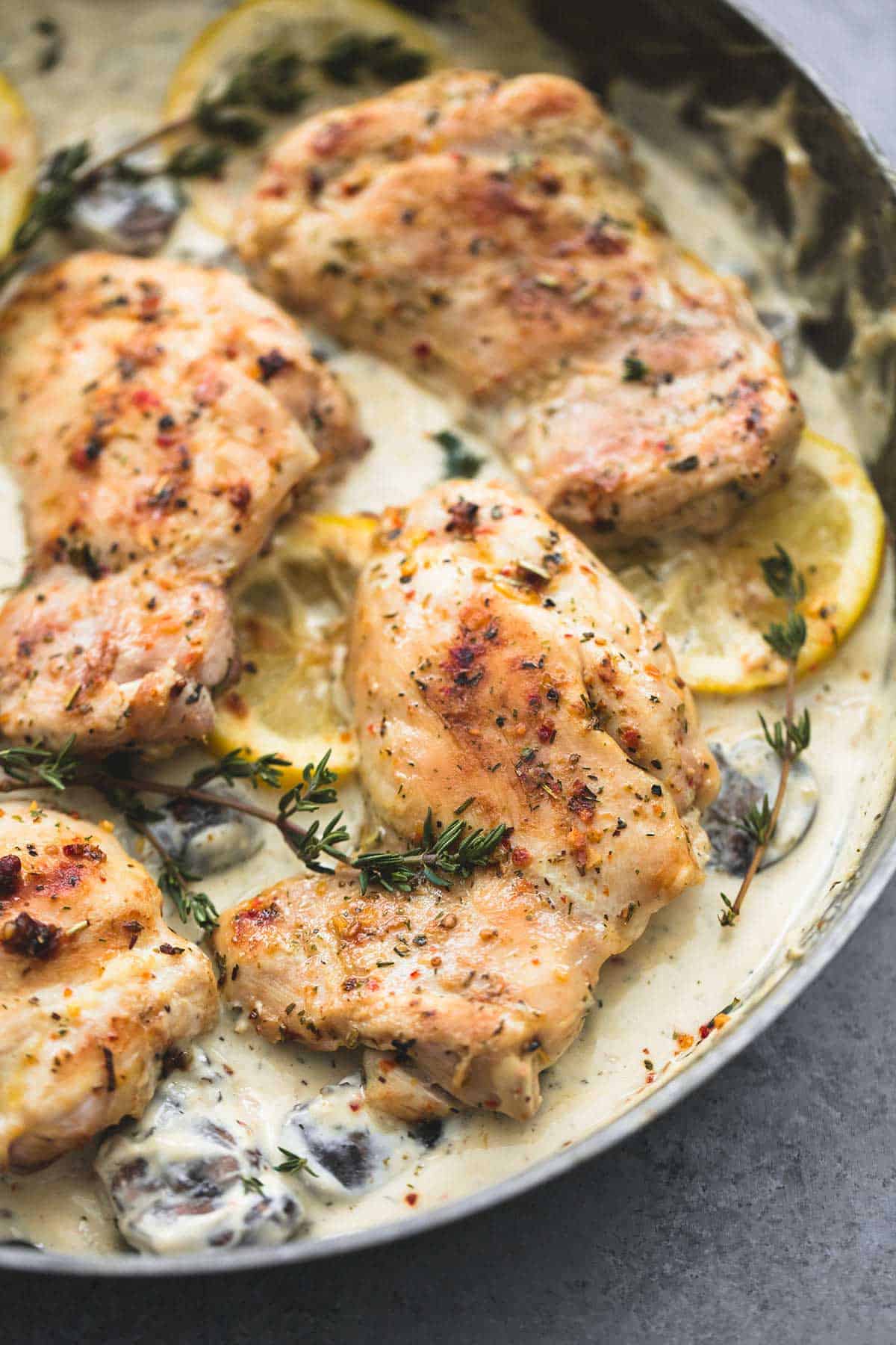 close up of creamy lemon thyme chicken in a pan.