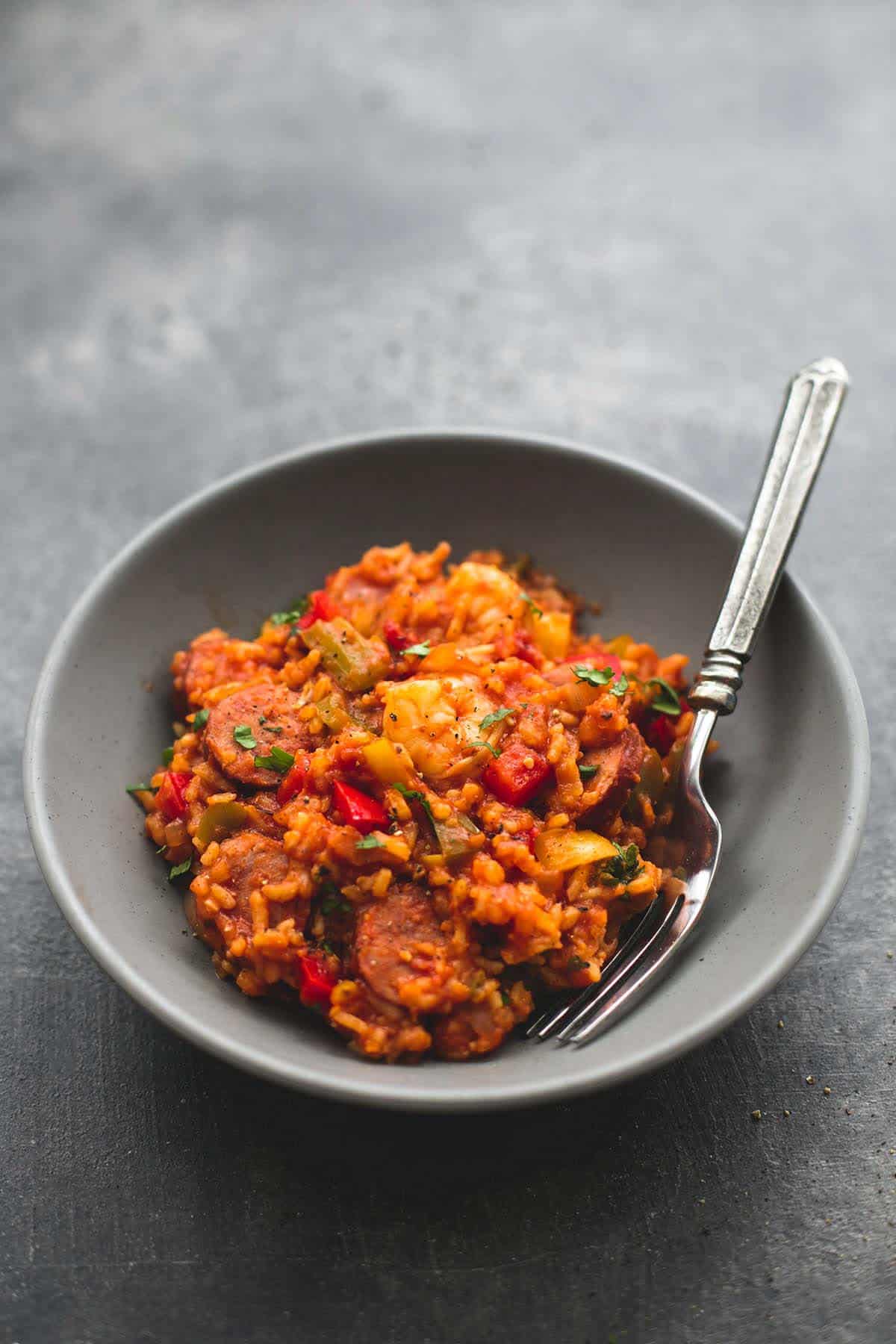 slow cooker jambalaya with a fork in a bowl.