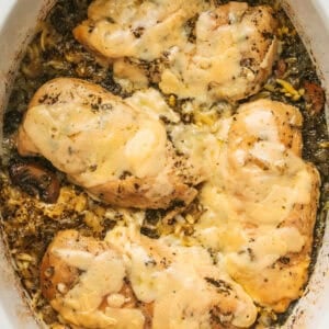 Overhead of slow cooker parmesan herb chicken and orzo in a slow cooker.