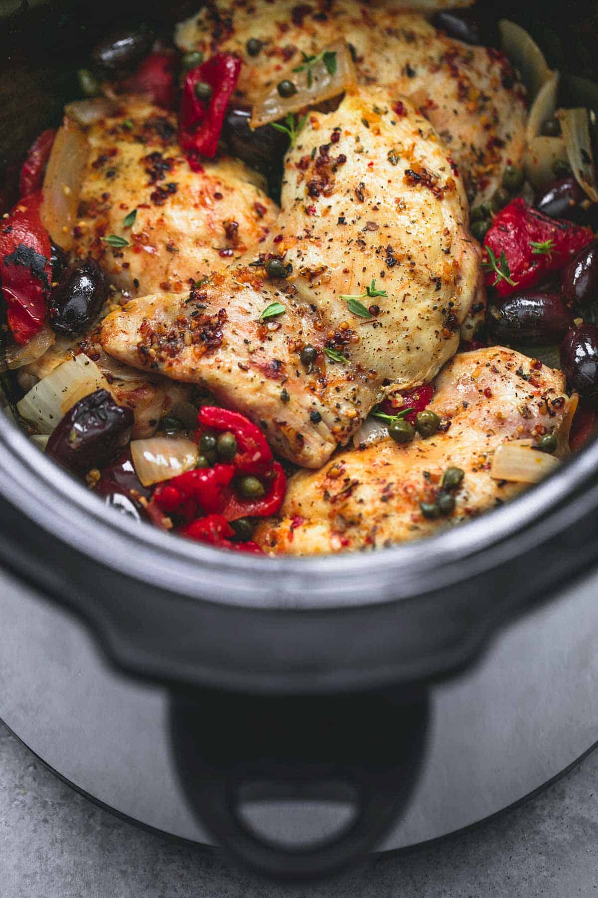 close up of slow cooker Mediterranean chicken in a slow cooker.