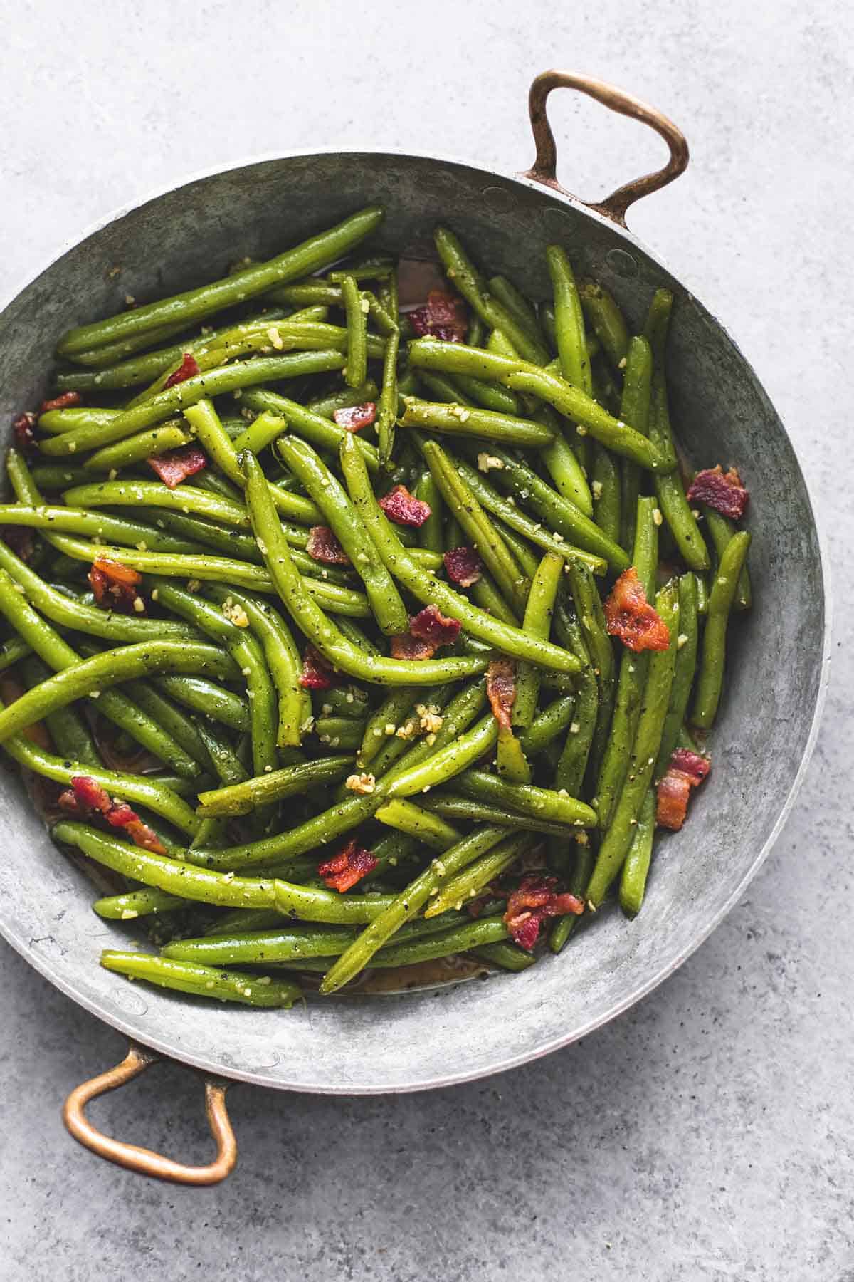 top view of brown sugar green beans with bacon in a wok.