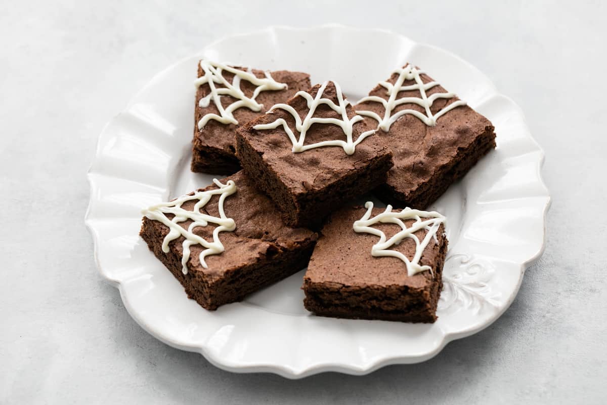 spider web Halloween brownies on a plate.