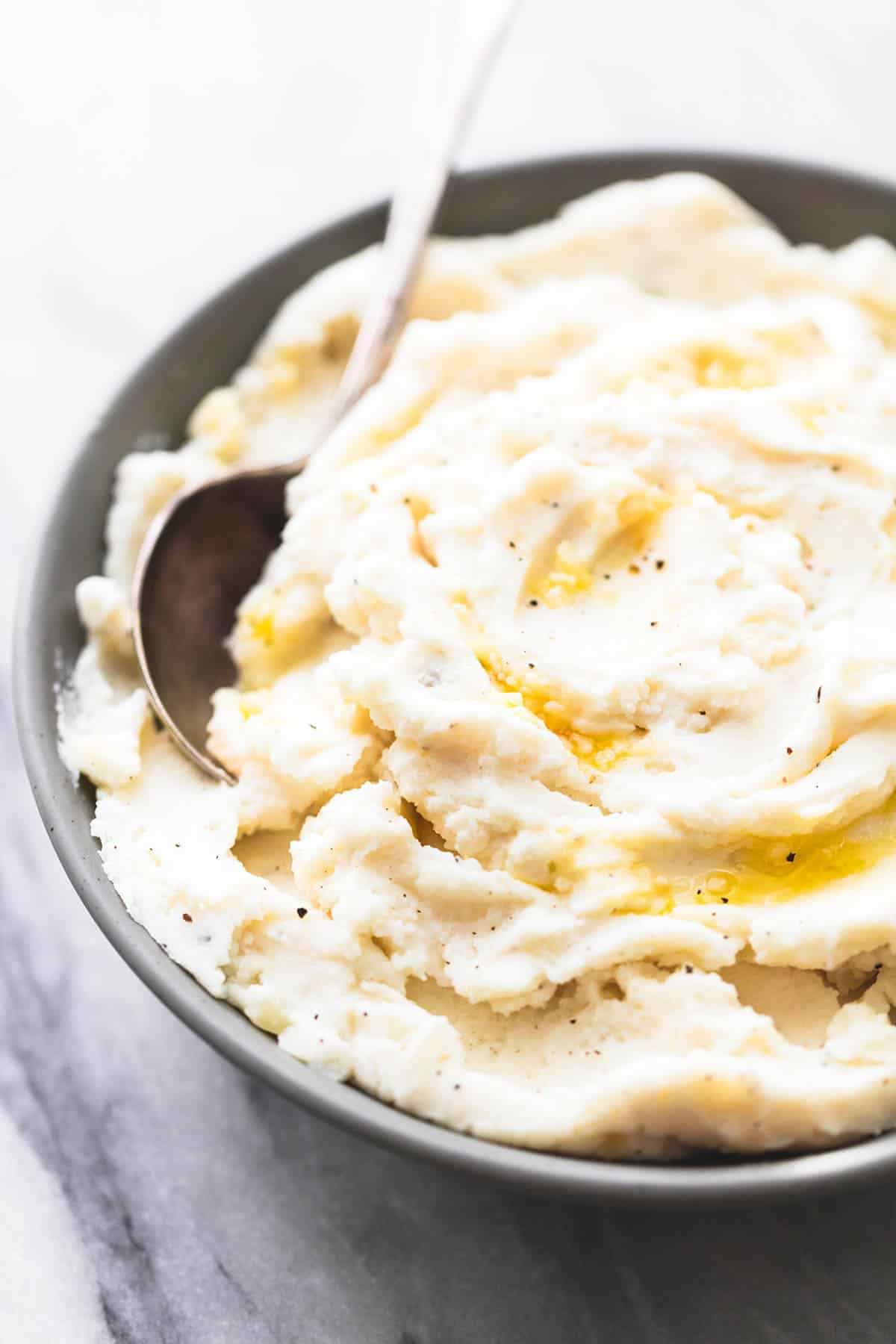 garlic sour cream mashed potatoes with a spoon in a bowl.