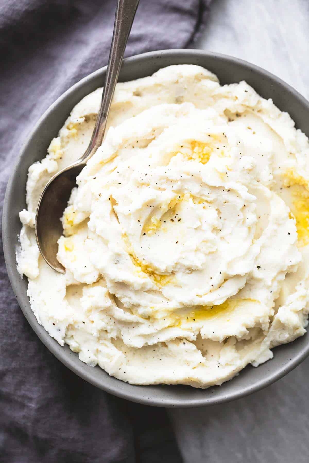top view of garlic sour cream mashed potatoes with a spoon in a bowl.