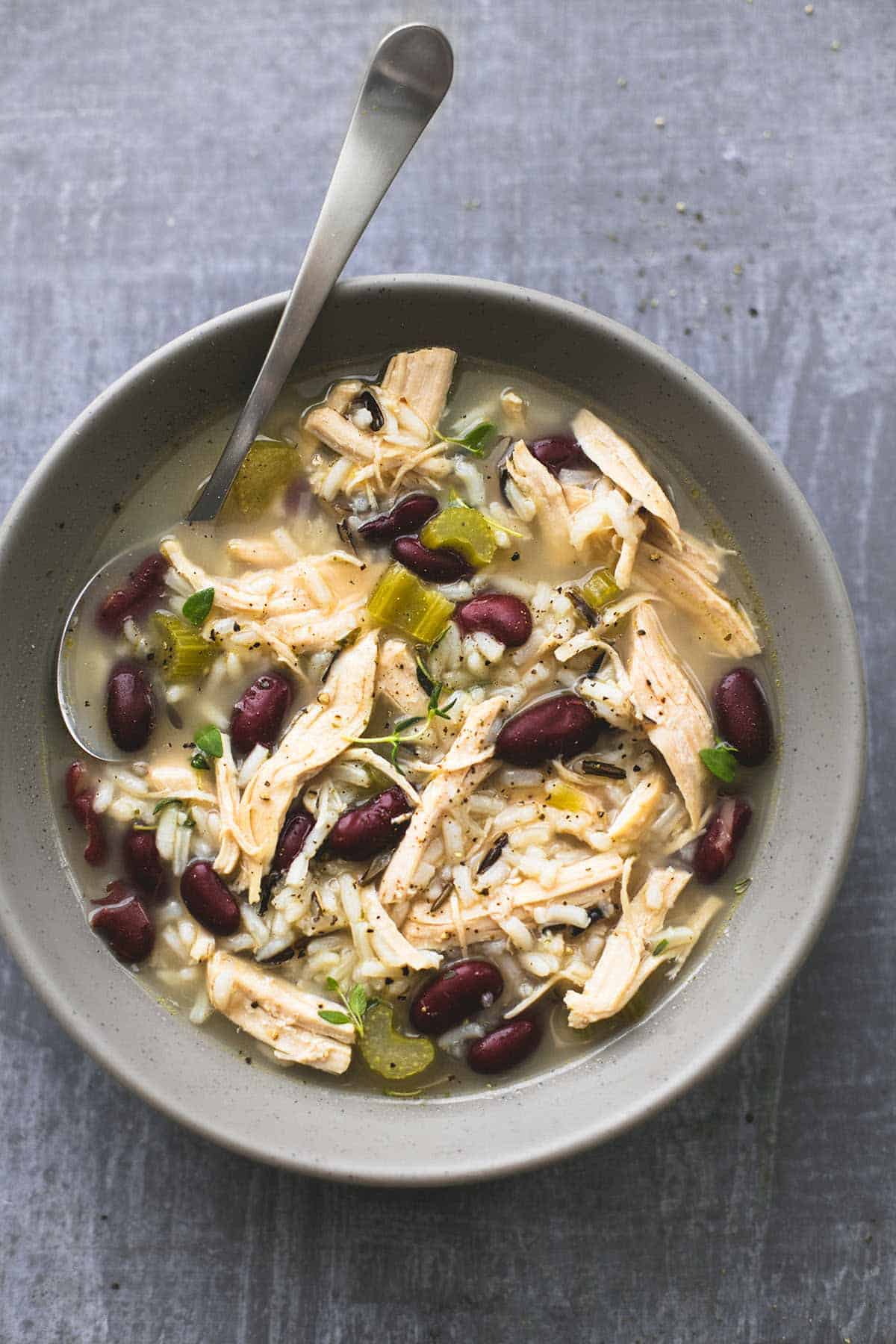 top view of healthy turkey wild rice soup with a spoon in a bowl.