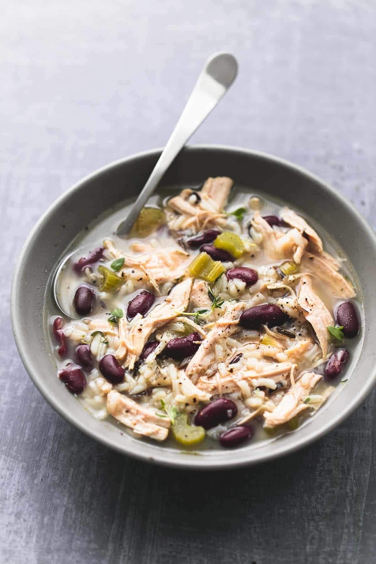 healthy turkey wild rice soup with a spoon in a bowl.