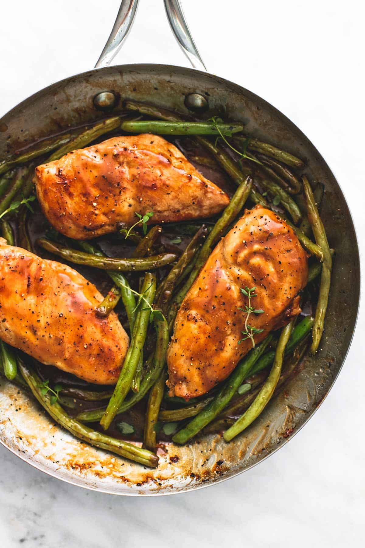 top view of creamy balsamic chicken & green beans in a pan.