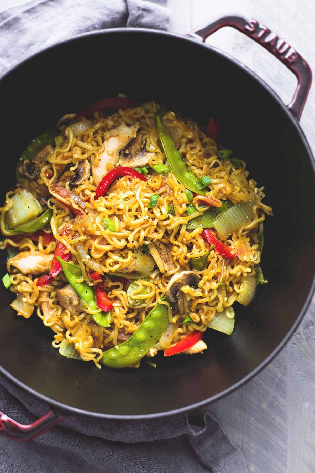 top view of chicken & veggie ramen in a wok.