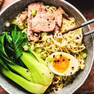 Overhead view of ramen with pork and bok choy in bowl.
