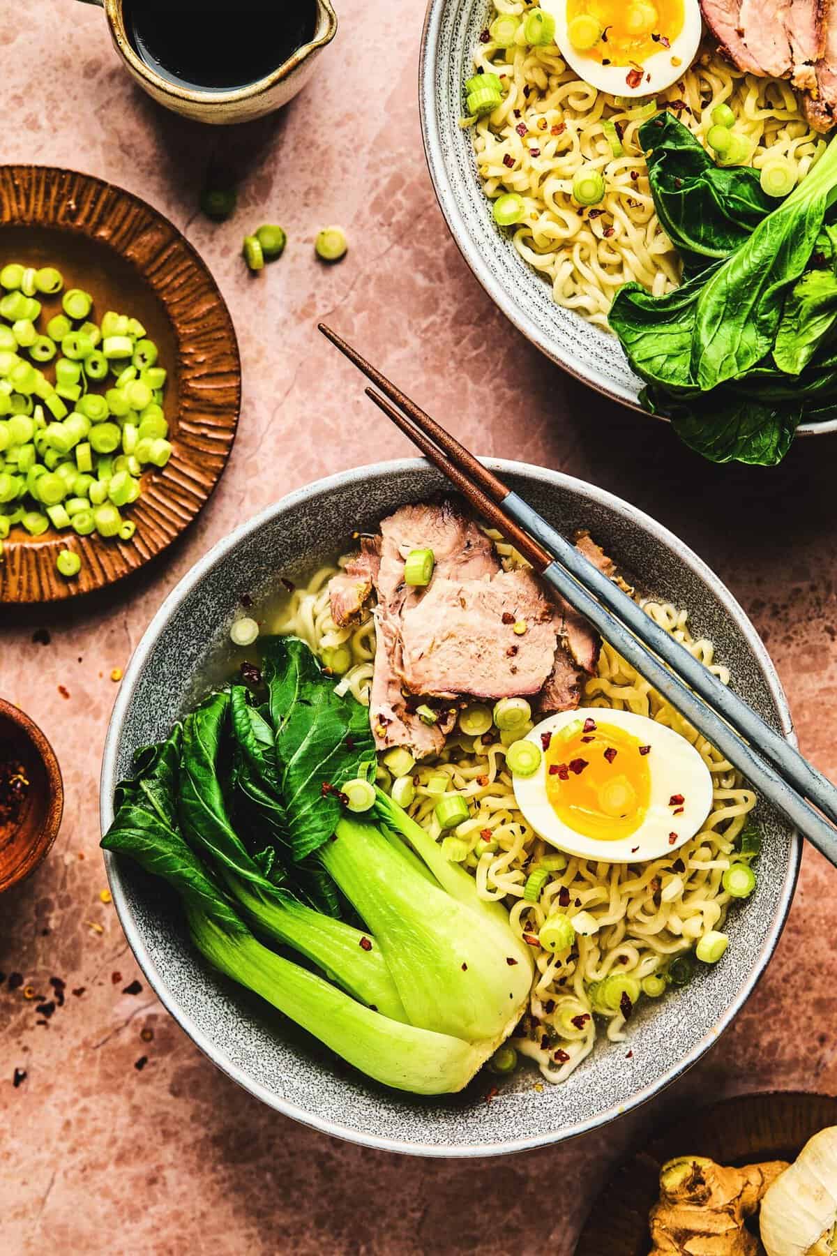 Bowl of pork ramen with soft boiled egg and bok choy. 