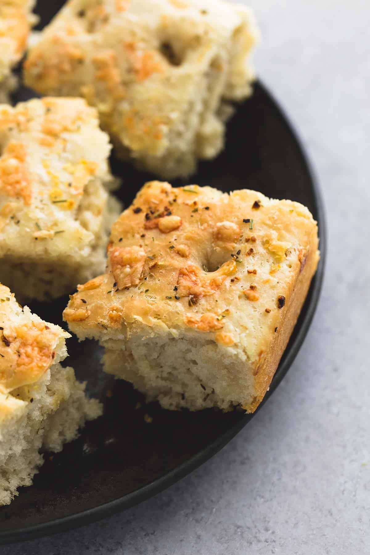 close up of focaccia bread pieces on a plate.