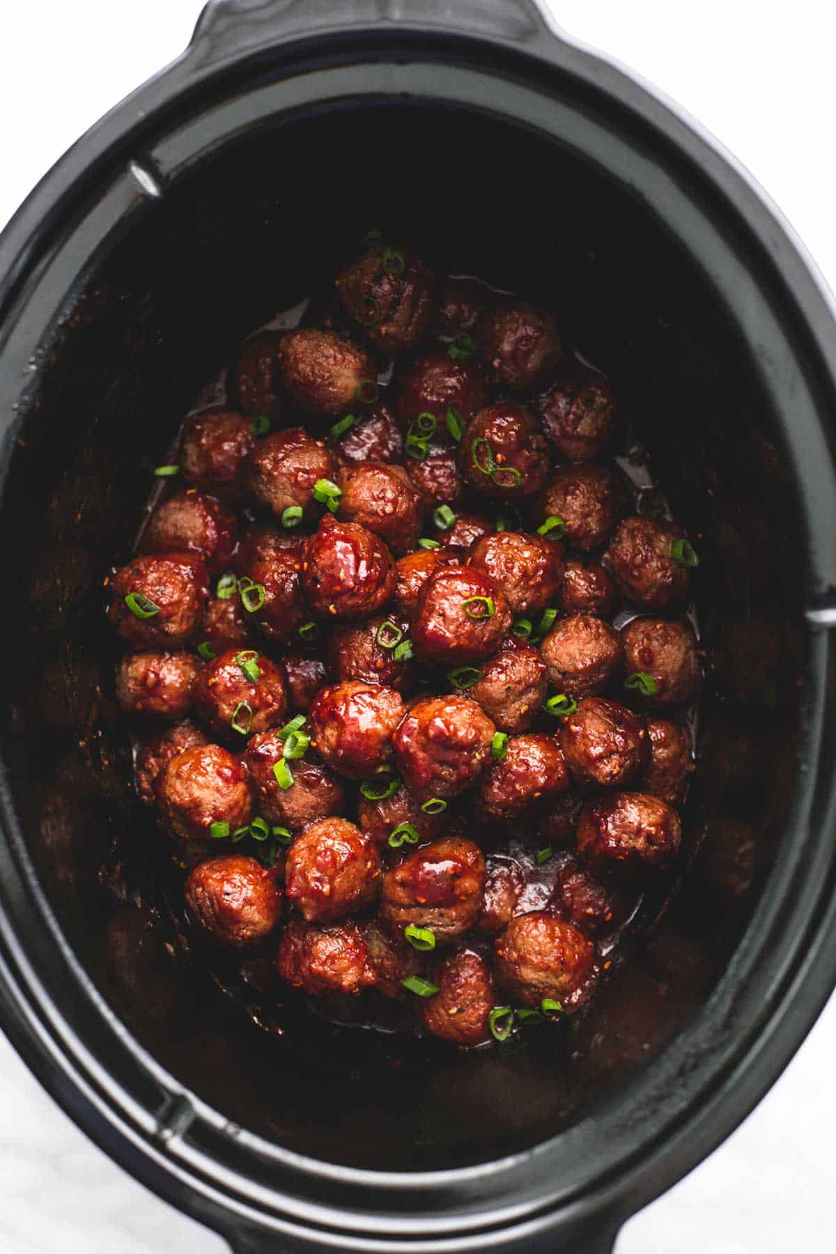 top view of slow cooker party meatballs in a slow cooker.