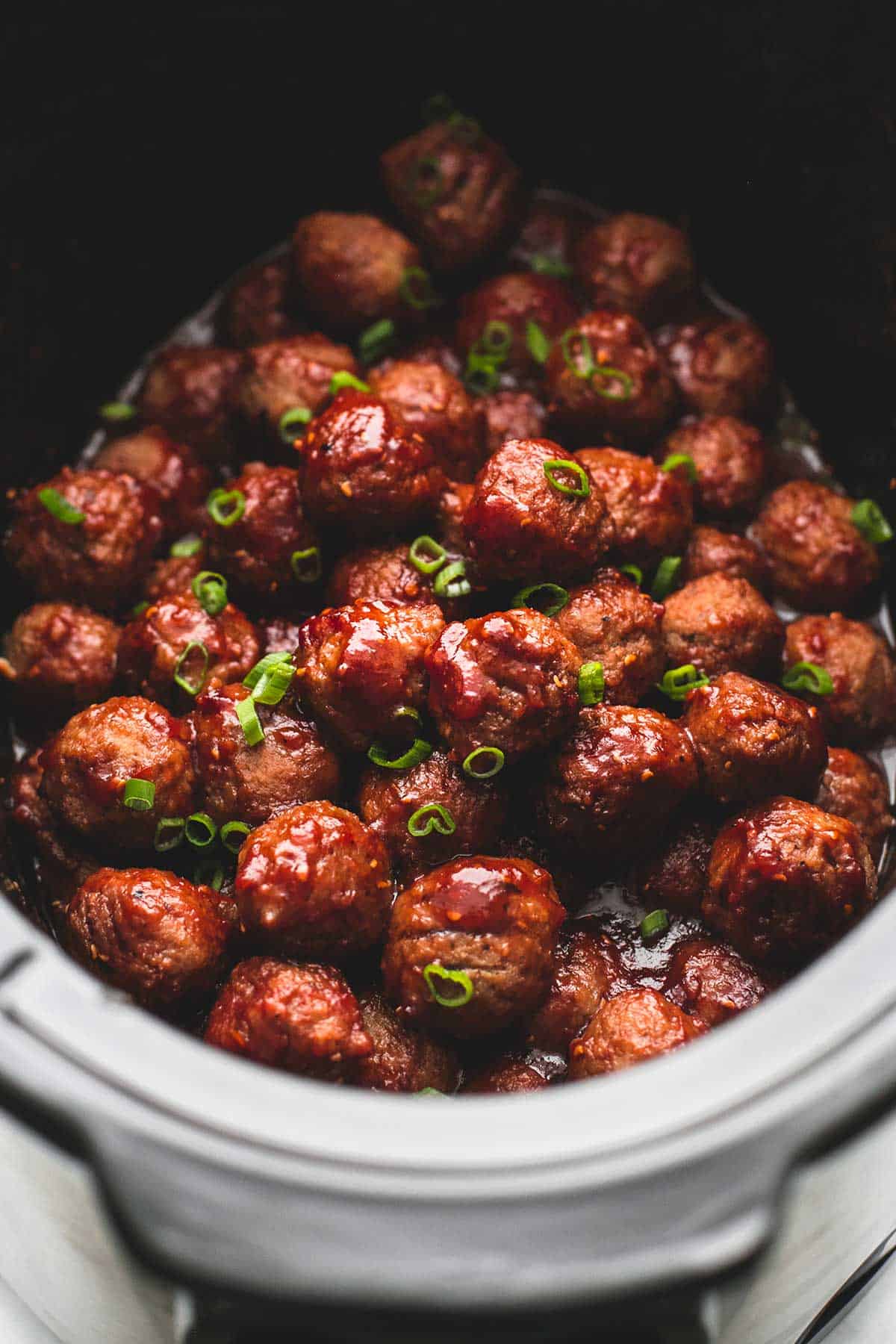 close up of slow cooker party meatballs in a slow cooker.