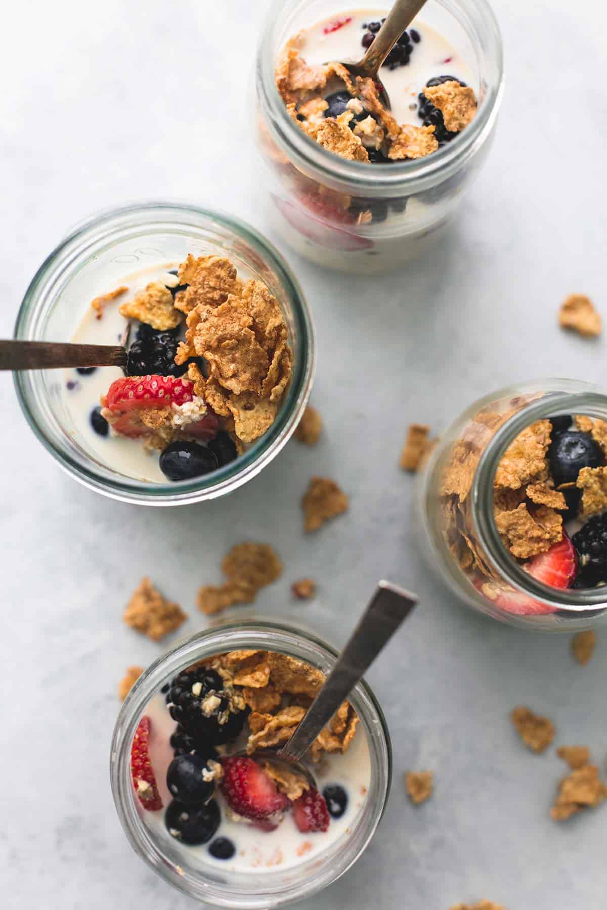 top view of berry crunch overnight oats with spoons in jars.