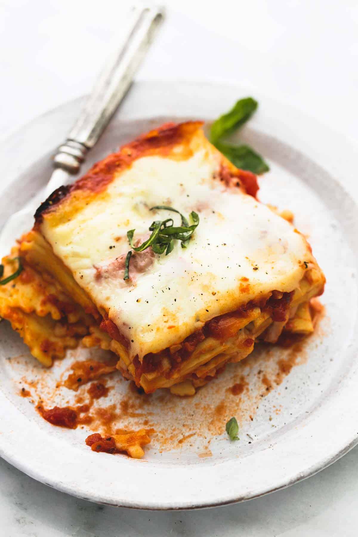 slow cooker ravioli lasagna with a fork on a plate.